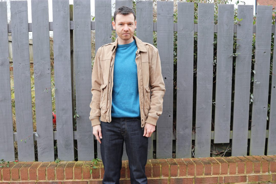 Suede jacket, blue jumper, denim jeans