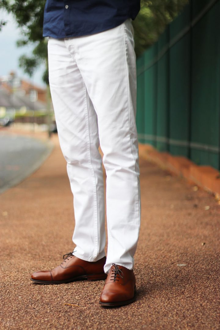 white shirt blue jeans and brown shoes